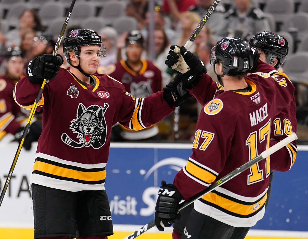 Chicago's Erik Brannstrom, left, celebrates a goal with teammate Brace Macek during an AHL game ...