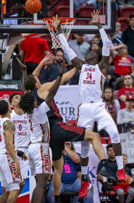 UNLV Rebels forward Cheikh Mbacke Diong (34, right) rejects a shot by San Diego State Aztecs fo ...