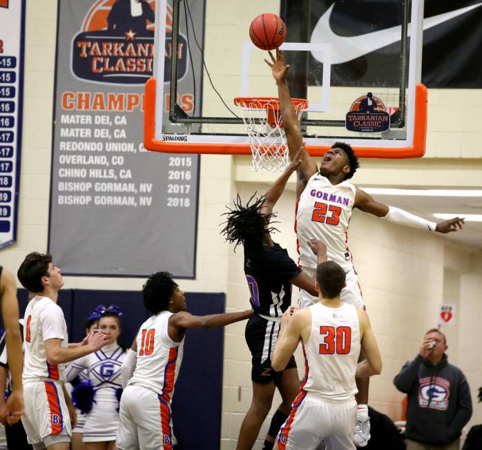 Bishop Gorman forward Mwani Wilkinson (23) blocks a shot by Durango guard Keshon Gilbert (10) i ...