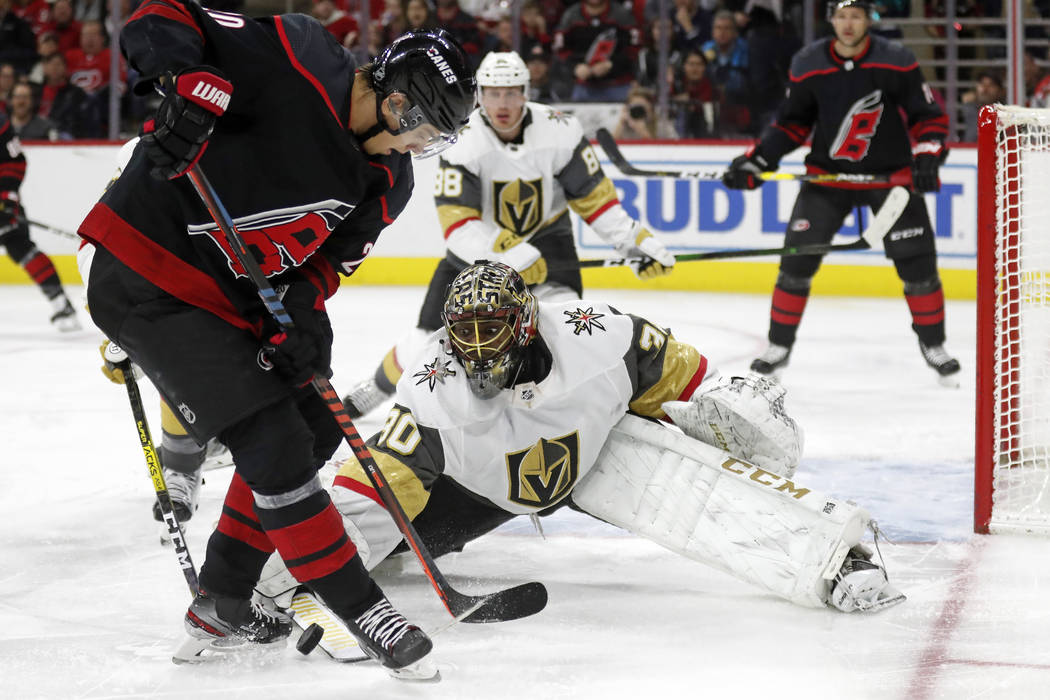 Carolina Hurricanes center Sebastian Aho is blocked by Vegas Golden Knights goaltender Malcolm ...