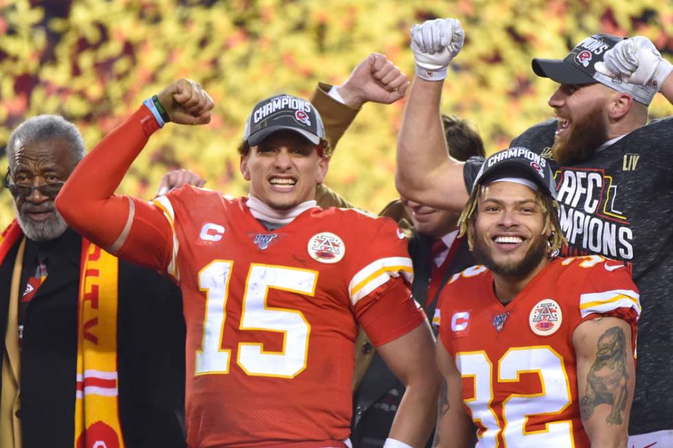 Kansas City Chiefs' Patrick Mahomes (15), Travis Kelce and Tyrann Mathieu (32) celebrate after ...