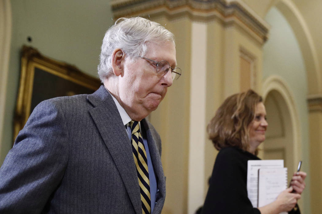 Senate Majority Leader Mitch McConnell of Ky., departs the chamber on Capitol Hill in Washingto ...