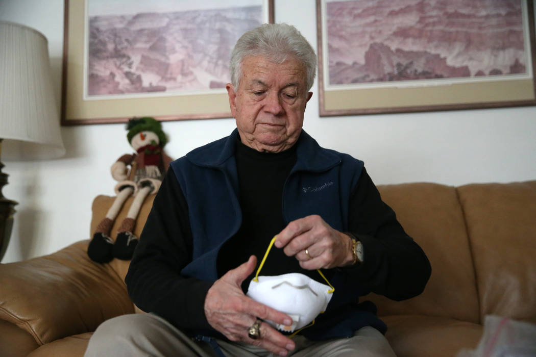 Former Las Vegas City Councilman Bob Coffin shows one of his old masks at his Las Vegas home, T ...