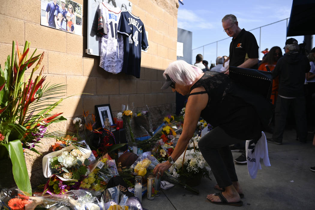 Judy Pratt lays flowers down at a memorial for John Altobelli, the late head coach of Orange Co ...