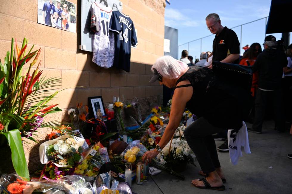 Judy Pratt lays flowers down at a memorial for John Altobelli, the late head coach of Orange Co ...