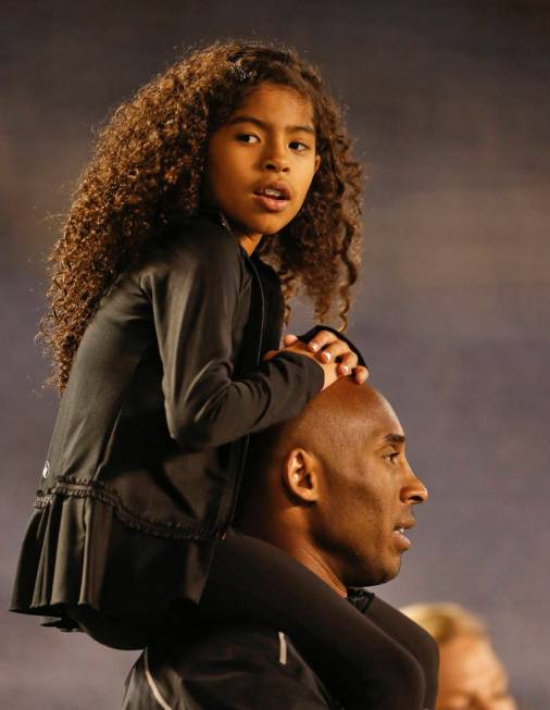 Gianna Maria-Onore Bryant sits on the shoulders of her father, Kobe, as they attend the women's ...