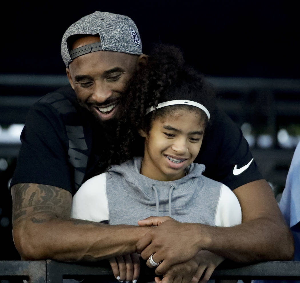 In a July 26, 2018 file photo former Los Angeles Laker Kobe Bryant and his daughter Gianna watc ...