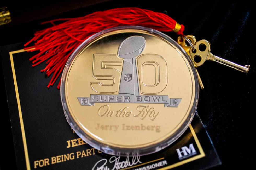 A coin celebrating long-time sports writer Jerry Izenberg's 50th Super Bowl at his home in Hend ...