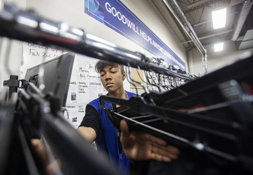 China Mitchell takes inventory of donated clothing at Goodwill of Southern Nevada on Wednesday, ...