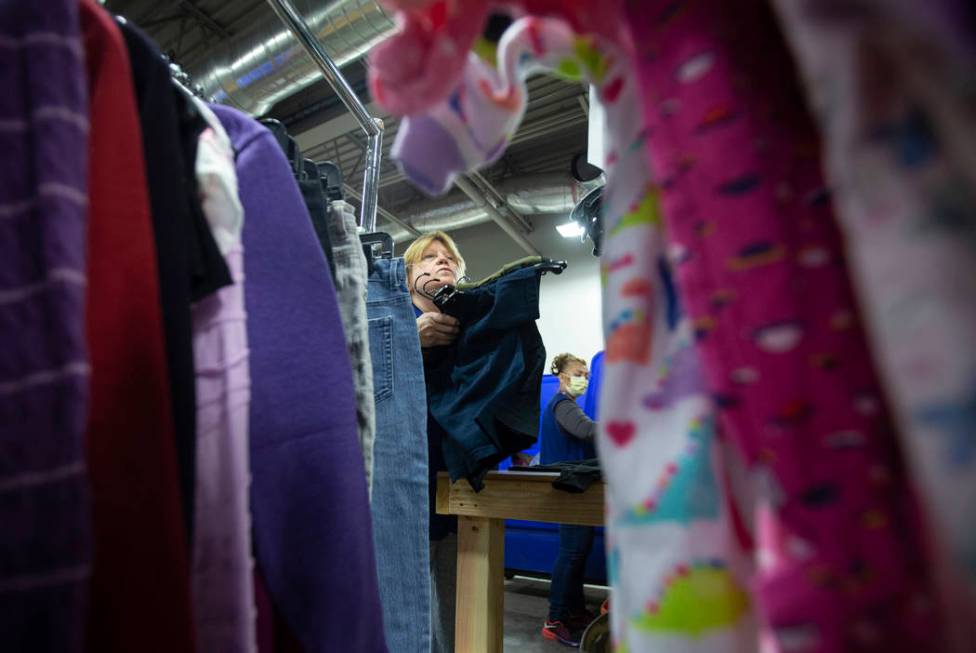 Linda Muth, top/left, sorts through donated clothing at Goodwill of Southern Nevada on Wednesda ...