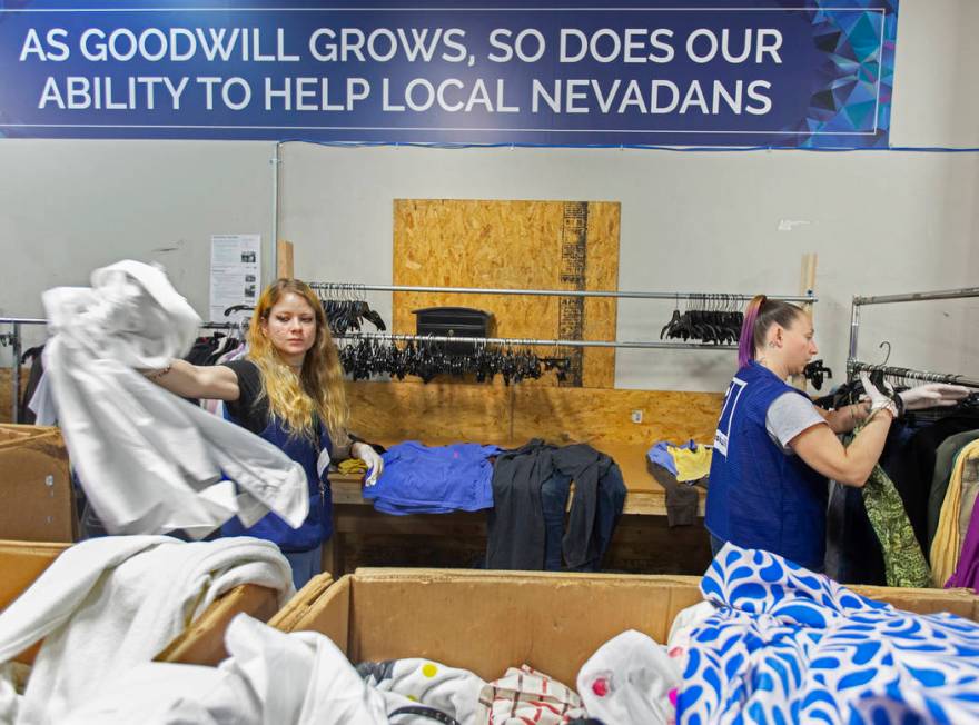 Shawnee Seay, left, and Katie Silber sort through donated clothing at Goodwill of Southern Neva ...