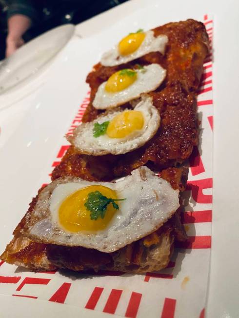 Coca sobrasada Menorquína (House-made sobrasada on pan de cristal bread with fried quail eggs ...