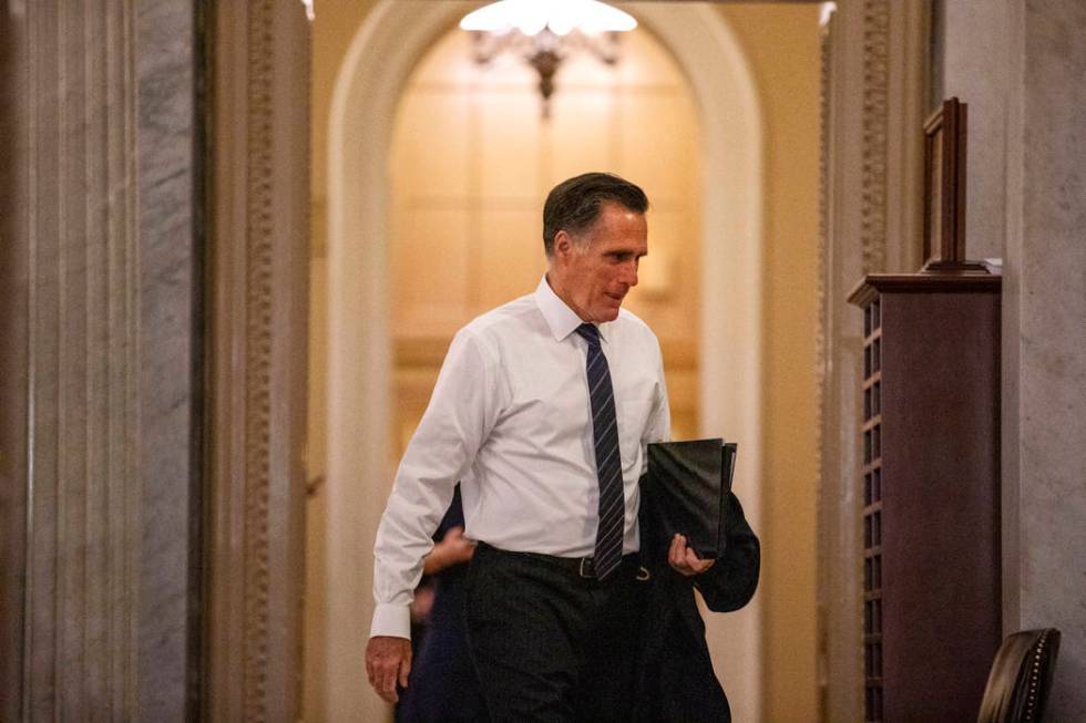 Sen. Mitt Romney, R-Utah, walks to the Senate chamber on Capitol Hill in Washington, Thursday, ...