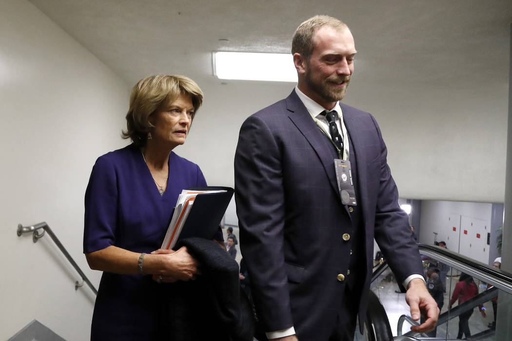 Sen. Lisa Murkowski, R-Alaska, left, arrives on Capitol Hill in Washington, Thursday, Jan. 30, ...