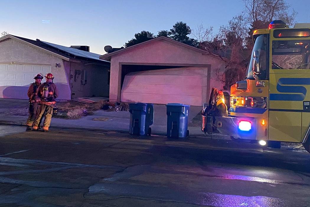 Firefighters clean up after a central Las Vegas house fire at 4317 Mott Circle, near Arville St ...