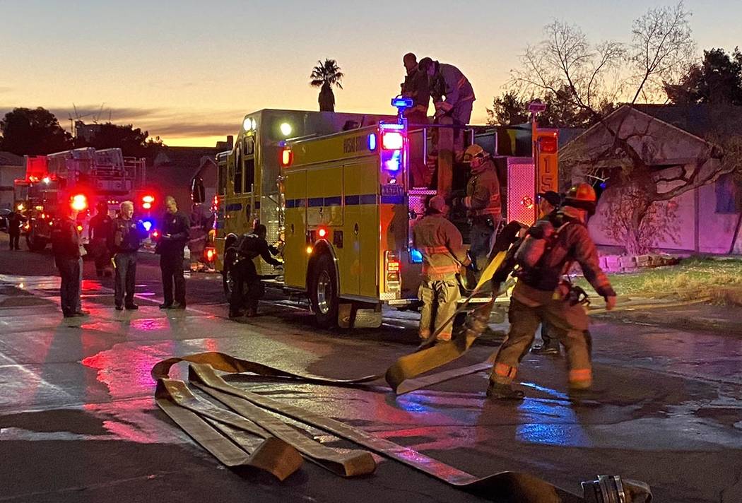 Firefighters clean up after a central Las Vegas house fire at 4317 Mott Circle, near Arville St ...