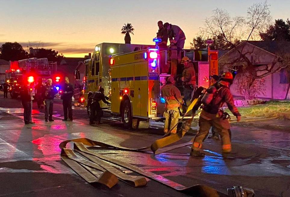 Firefighters clean up after a central Las Vegas house fire at 4317 Mott Circle, near Arville St ...