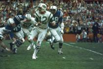 New York Jets quarterback (12) Joe Namath gets off a pass under pressure from the Baltimore Col ...