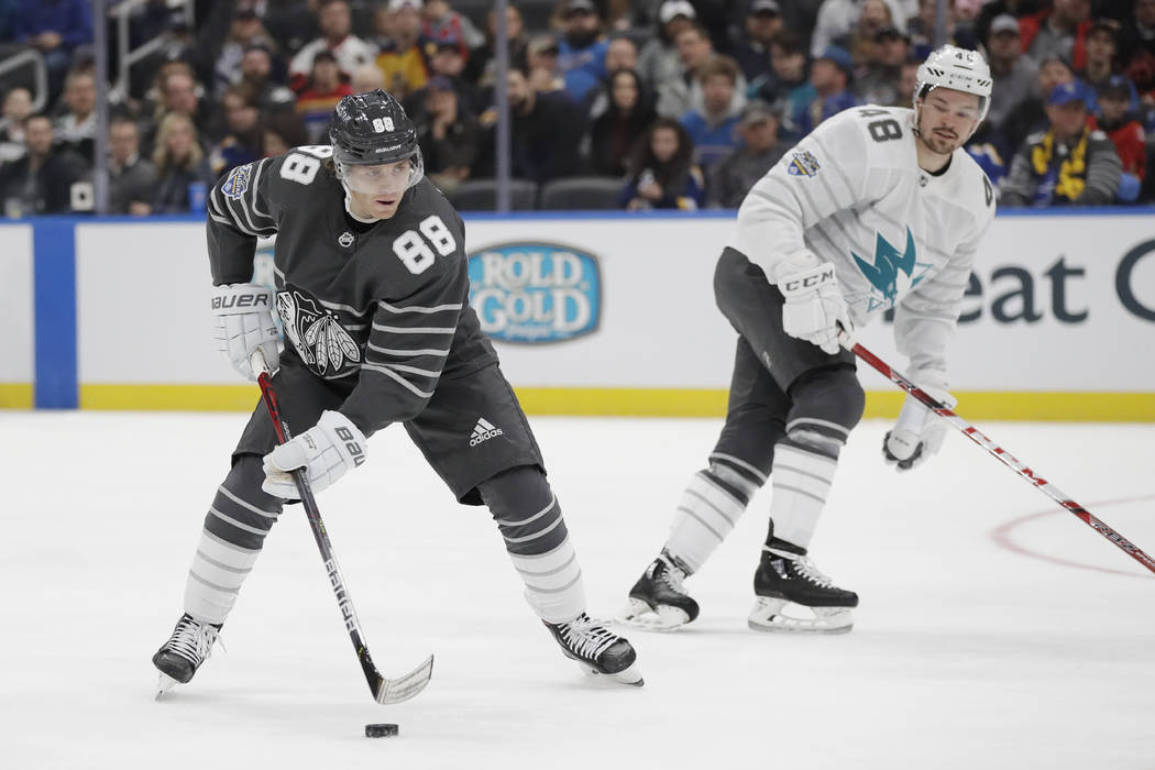 Chicago Blackhawks forward Patrick Kane (88) moves the puck against San Jose Sharks forward Tom ...