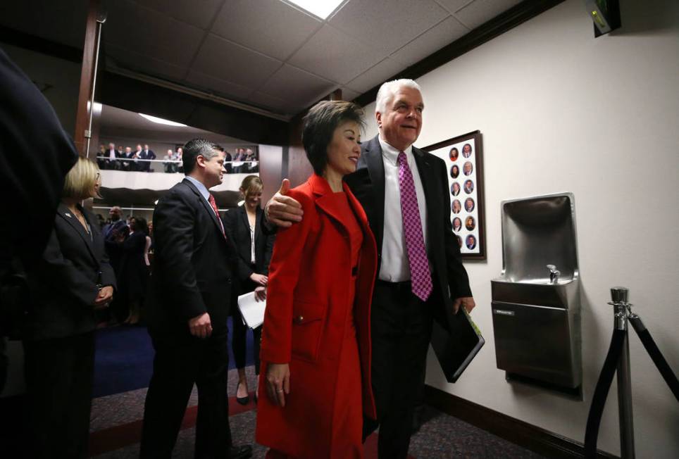 Nevada Gov. Steve Sisolak and his wife Kathy leave the Assembly chambers after delivering his S ...