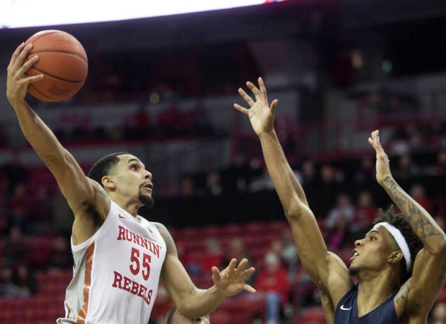 UNLV Rebels guard Elijah Mitrou-Long (55) drives over Jackson State Tigers guard Venjie Wallis ...