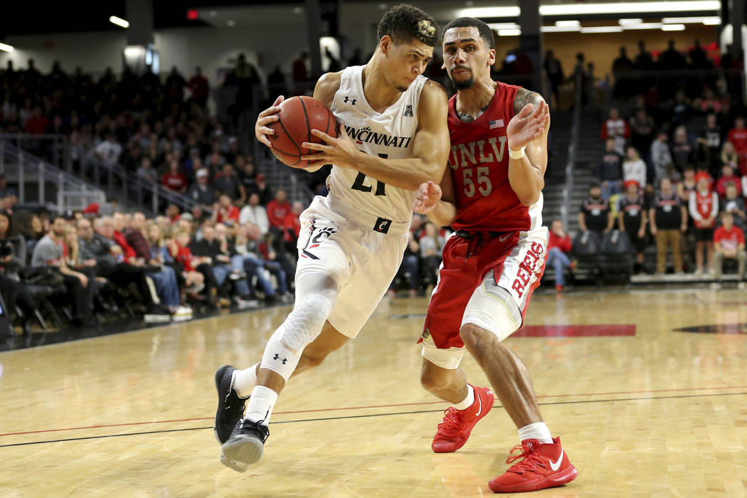 Cincinnati guard Jaevin Cumberland (21) drives to the basket as UNLV guard Elijah Mitrou-Long ( ...