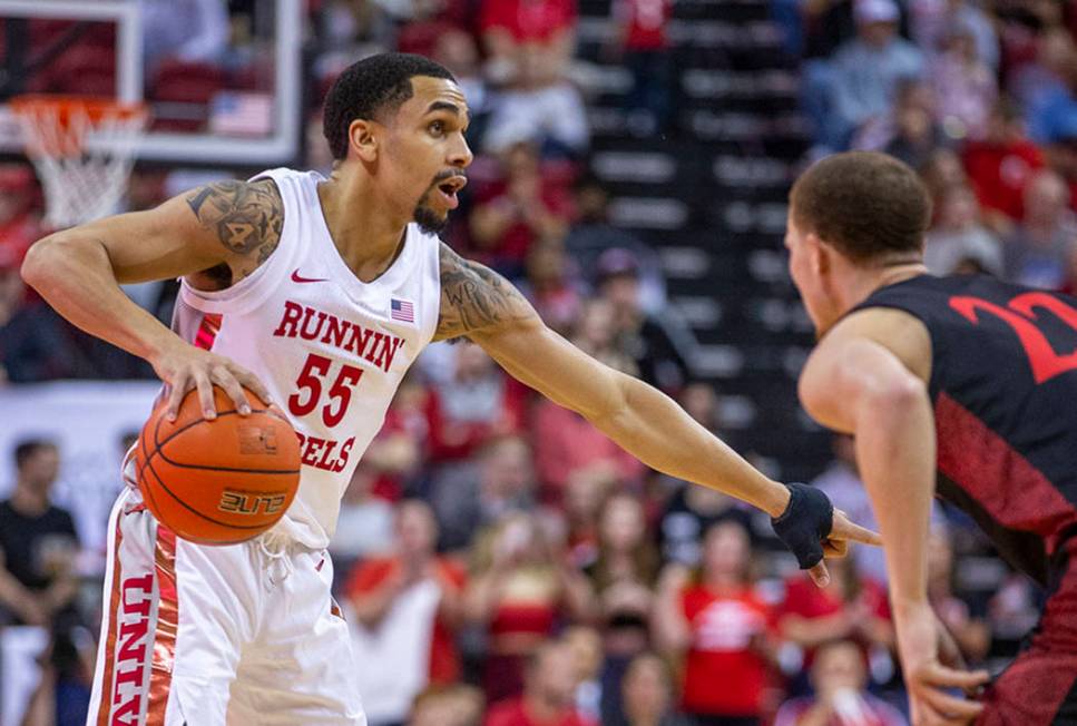 UNLV Rebels guard Elijah Mitrou-Long (55, left) signals to a teammate while guarded by San Dieg ...