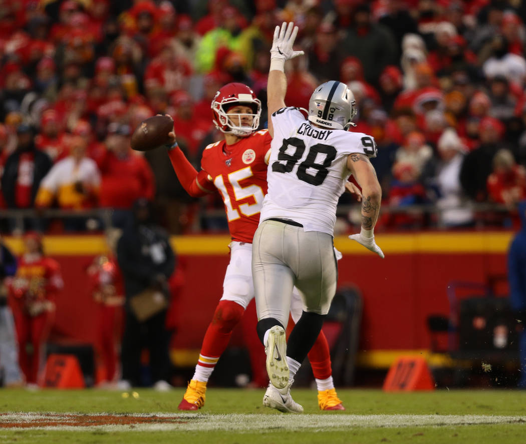 Oakland Raiders defensive end Maxx Crosby (98) tries to deflect a pass thrown by Kansas City Ch ...