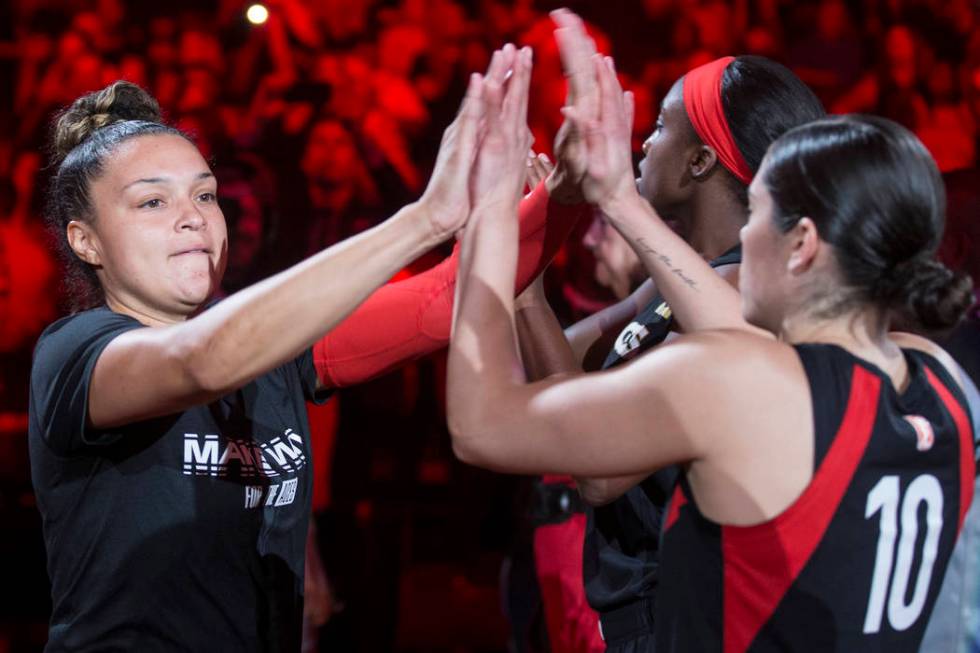 Las Vegas Aces guard Kayla McBride (21) high fives Las Vegas Aces guard Kelsey Plum (10) before ...