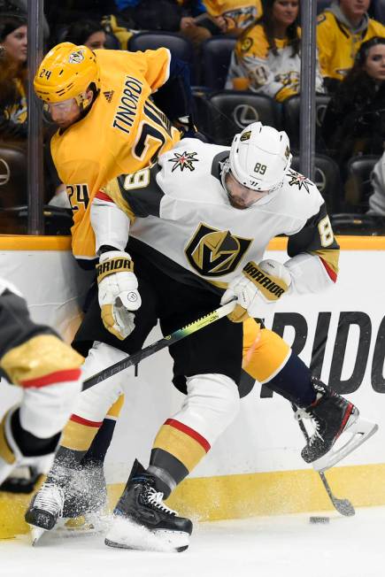 Vegas Golden Knights right wing Alex Tuch (89) and Nashville Predators defenseman Jarred Tinord ...