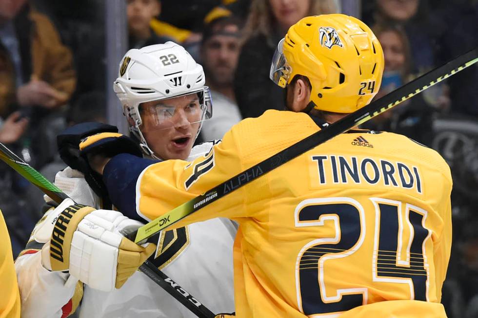 Vegas Golden Knights defenseman Nick Holden (22) scuffles with Nashville Predators defenseman J ...