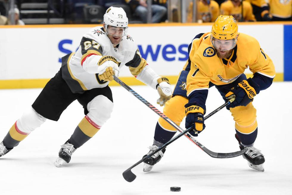 Nashville Predators defenseman Yannick Weber (7), of Switzerland, gets control of the puck in f ...