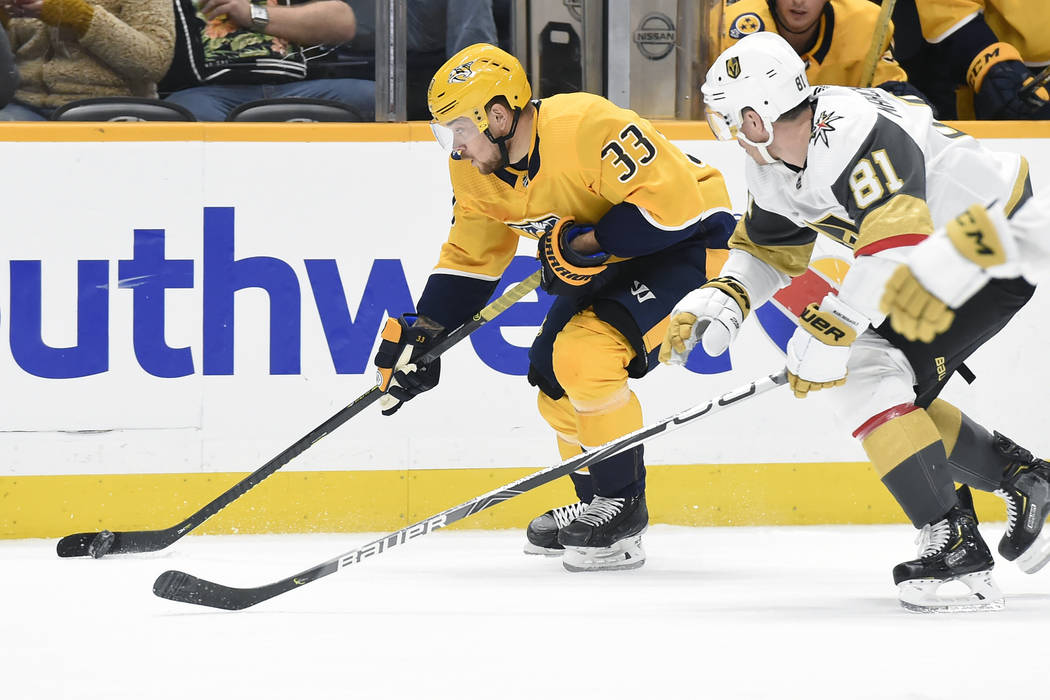 Nashville Predators right wing Viktor Arvidsson (33), of Sweden, moves the puck ahead of Vegas ...