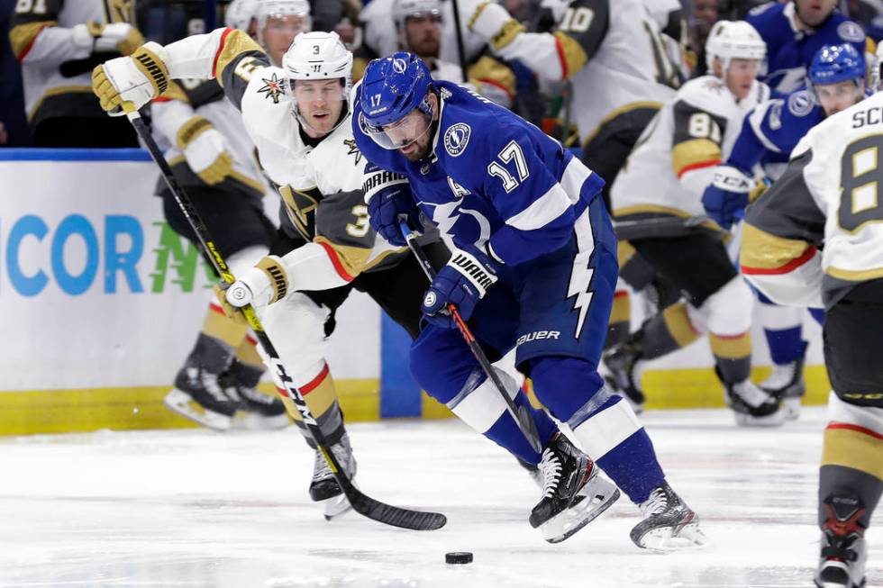 Tampa Bay Lightning left wing Alex Killorn (17) breaks out ahead of Vegas Golden Knights defens ...