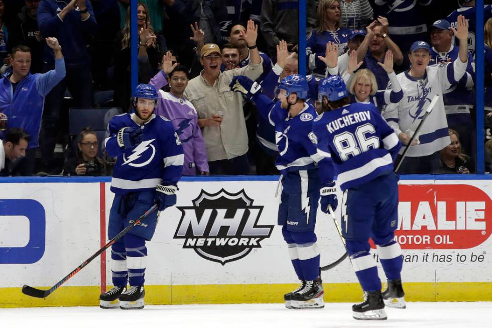 Tampa Bay Lightning center Brayden Point (21) celebrates with center Steven Stamkos (91) and ri ...