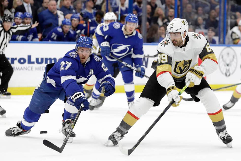 Vegas Golden Knights right wing Alex Tuch (89) flips the puck past Tampa Bay Lightning defensem ...