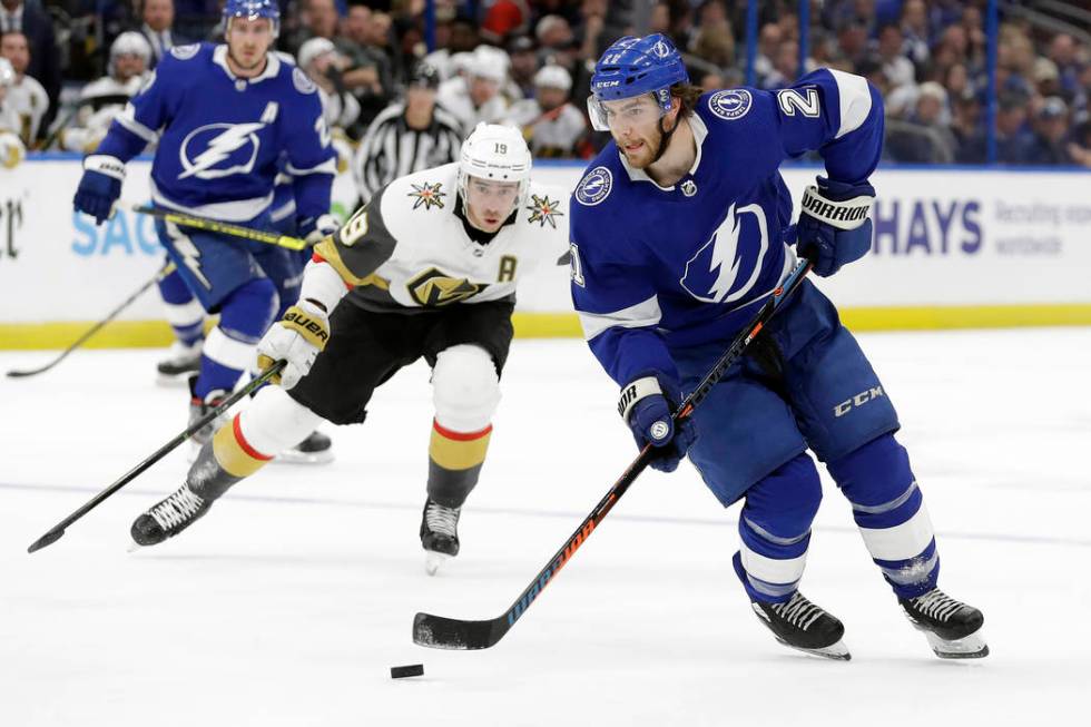 Tampa Bay Lightning center Brayden Point (21) carries the puck around Vegas Golden Knights righ ...