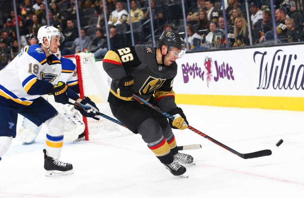 Golden Knights' Paul Stastny (26) eyes the puck in front of St. Louis Blues' Jay Bouwmeester (1 ...