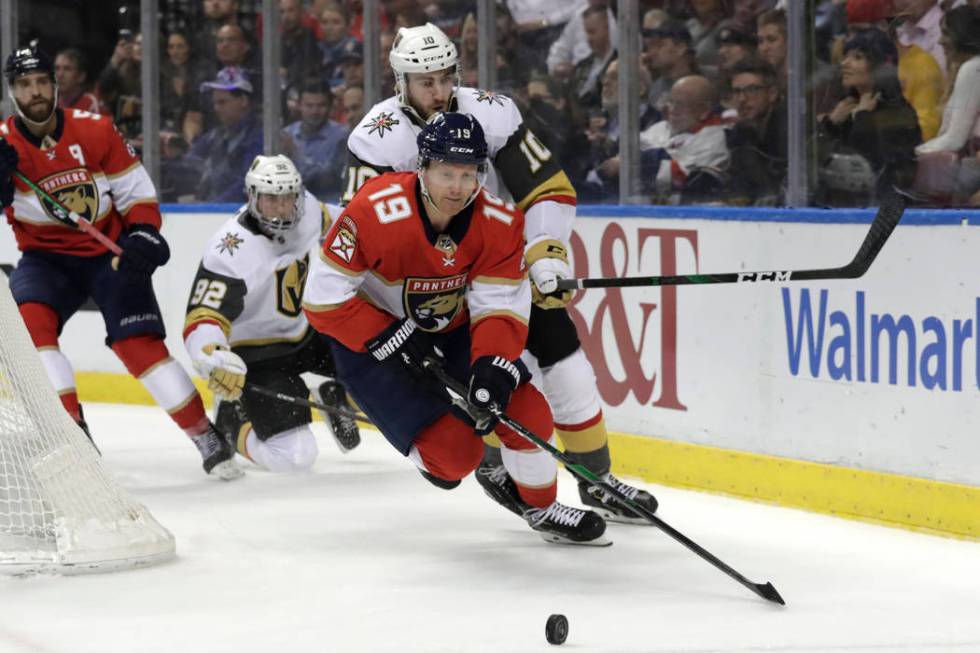 Florida Panthers defenseman Mike Matheson (19) and Vegas Golden Knights center Nicolas Roy (10) ...