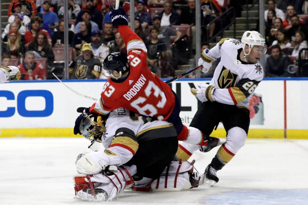 Florida Panthers right wing Evgenii Dadonov (63) collides with Vegas Golden Knights goaltender ...