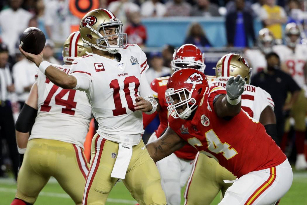 San Francisco 49ers' Tarvarius Moore, left, intercepts a pass against the Kansas City Chiefs du ...