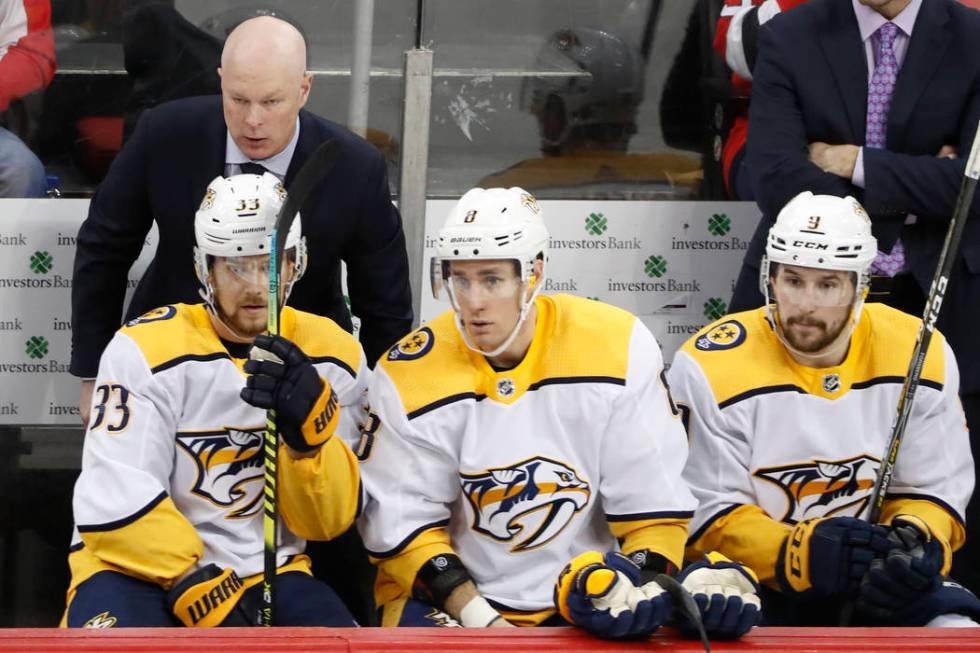 Nashville Predators head coach John Hynes, upper left, leans in to his players during a timeout ...