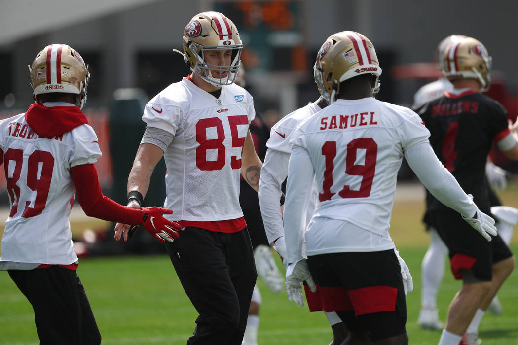 San Francisco 49ers tight end George Kittle (85) greets wide receivers Chris Thompson (89) and ...