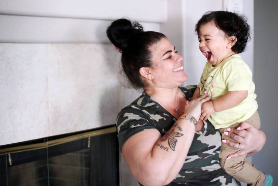 Hanna Olivas plays with her grandchild Damian Cordova, 1, at her home in Las Vegas, Wednesday, ...