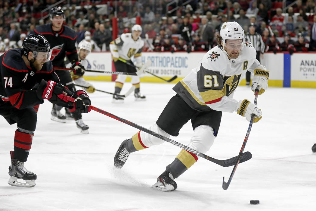 Carolina Hurricanes defenseman Jaccob Slavin (74) reaches for Vegas Golden Knights right wing M ...