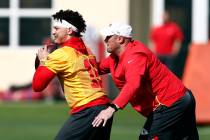 Kansas City Chiefs quarterback Patrick Mahomes (15) runs drills with coach Mike Kafka during pr ...