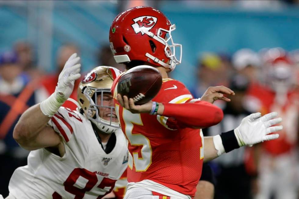 Kansas City Chiefs quarterback Patrick Mahomes passes under pressure from San Francisco 49ers' ...