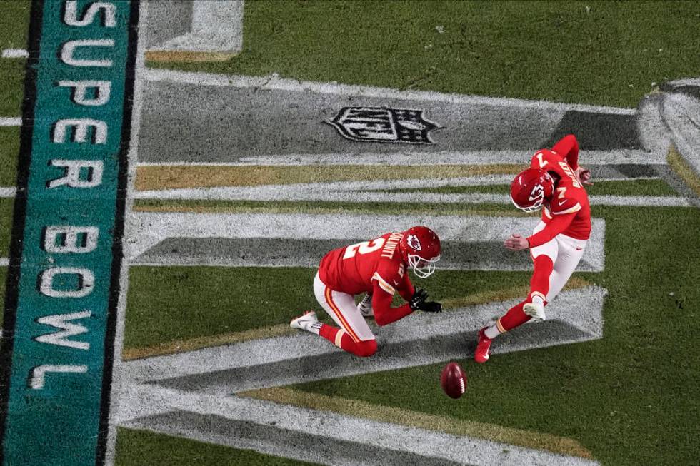 Kansas City Chiefs' Harrison Butker (7) scores the extra point as Dustin Colquitt (2) holds, du ...