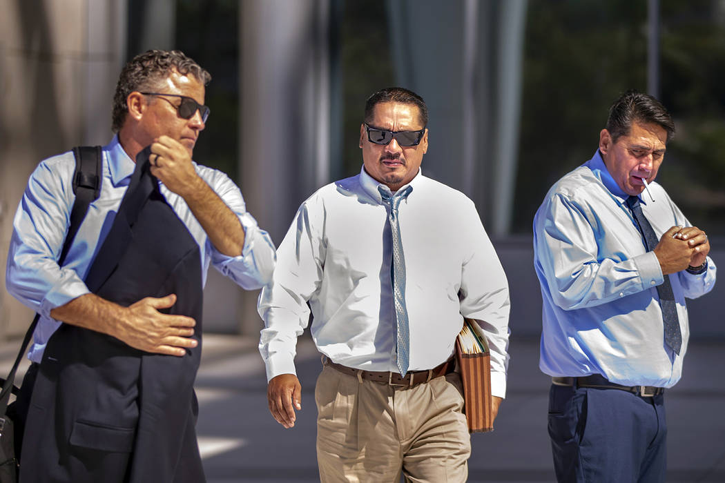 Lawyer Mark Fleming, left, walks with defendant Albert Lopez past defendant Bradley Campos outs ...