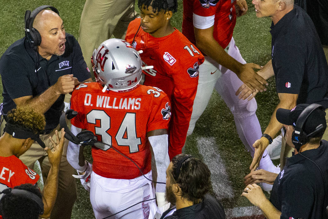 UNLV Rebels head coach Tony Sanchez, left, congratulates running back Darran Williams (34) on h ...